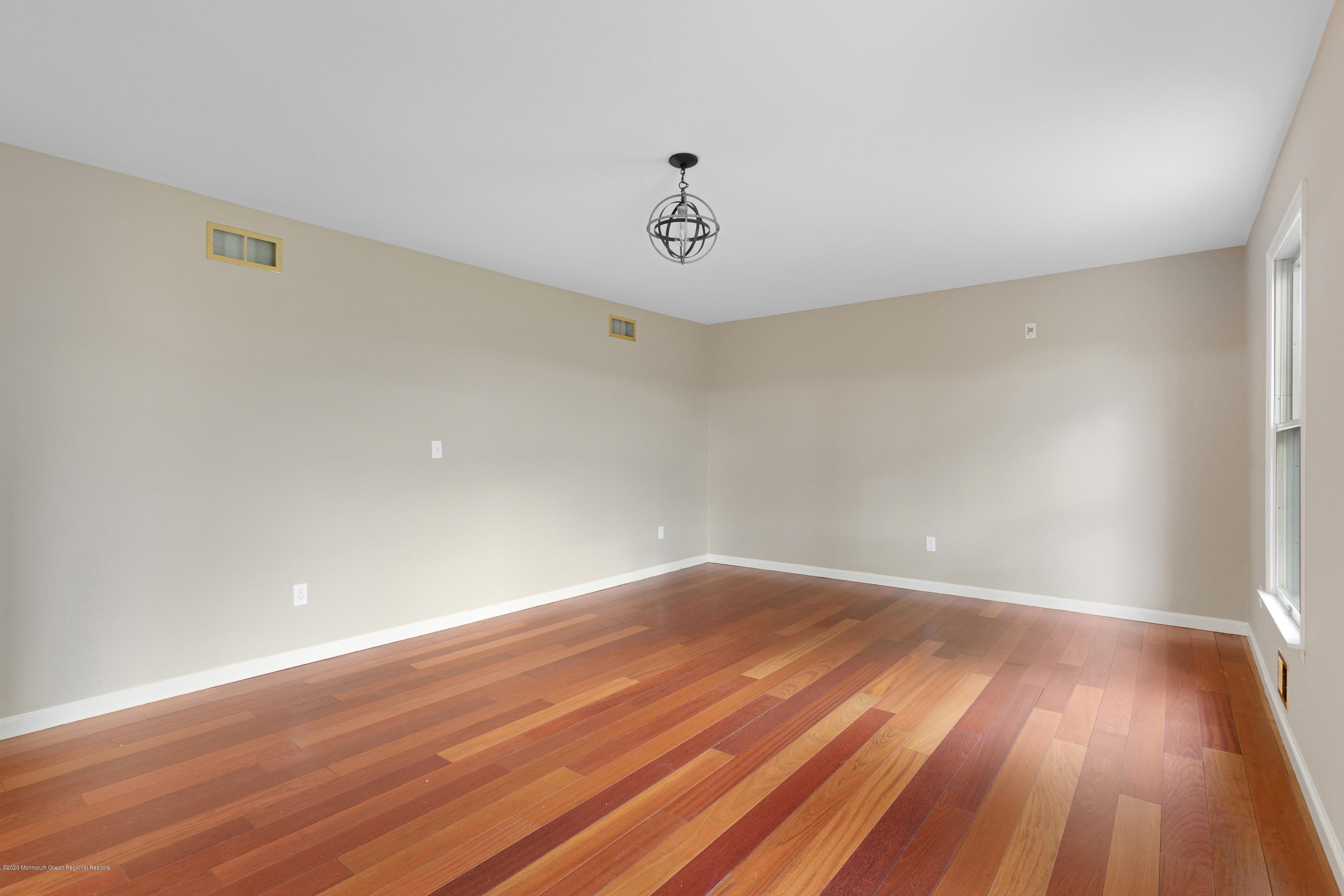 202 Adelphia Road Farmingdale, NJ 07727 - Photo 6 of 40 a view of an empty room with wooden floor and a window