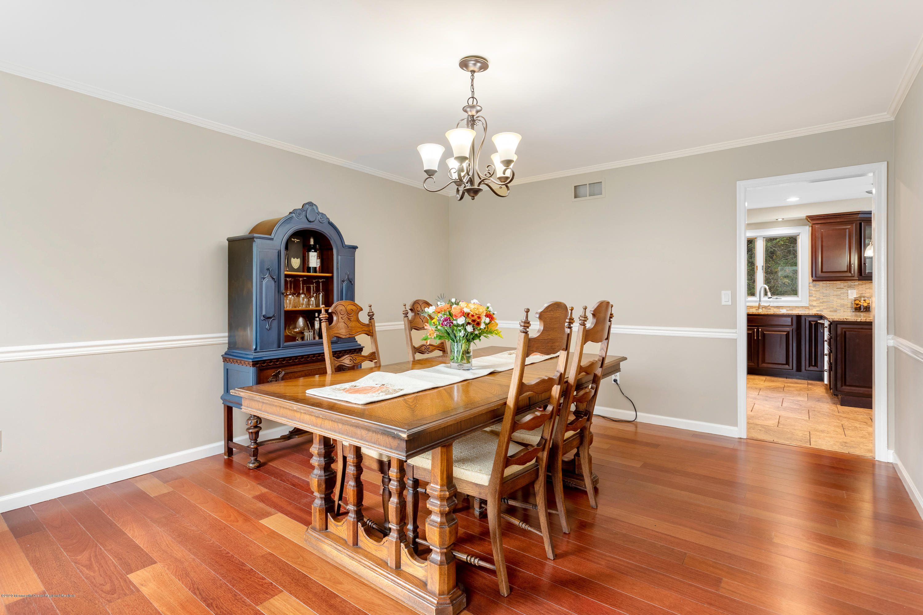 202 Adelphia Road Farmingdale, NJ 07727 - Photo 9 of 40 a view of a dining room with furniture a chandelier and wooden floor