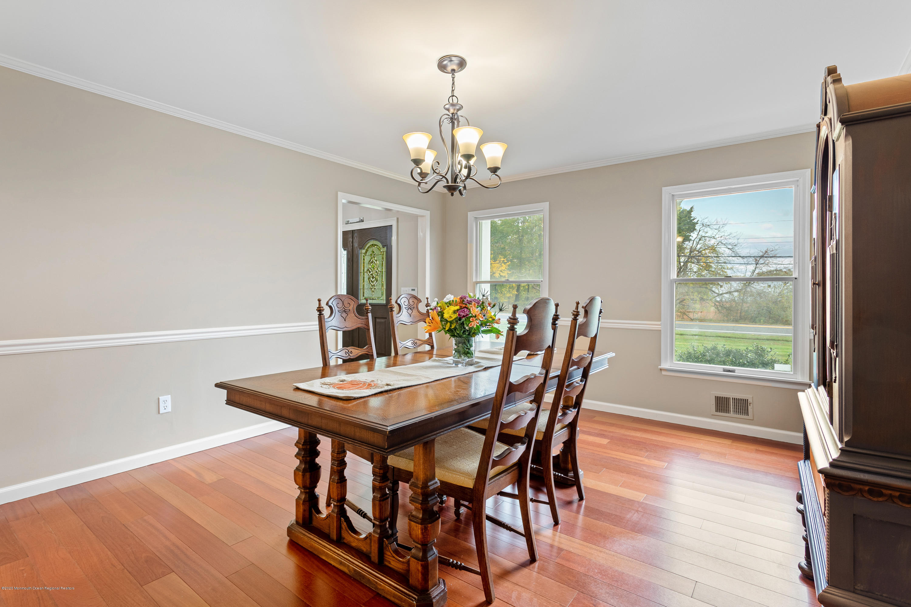 202 Adelphia Road Farmingdale, NJ 07727 - Photo 10 of 40 a view of a dining room with furniture a chandelier and wooden floor