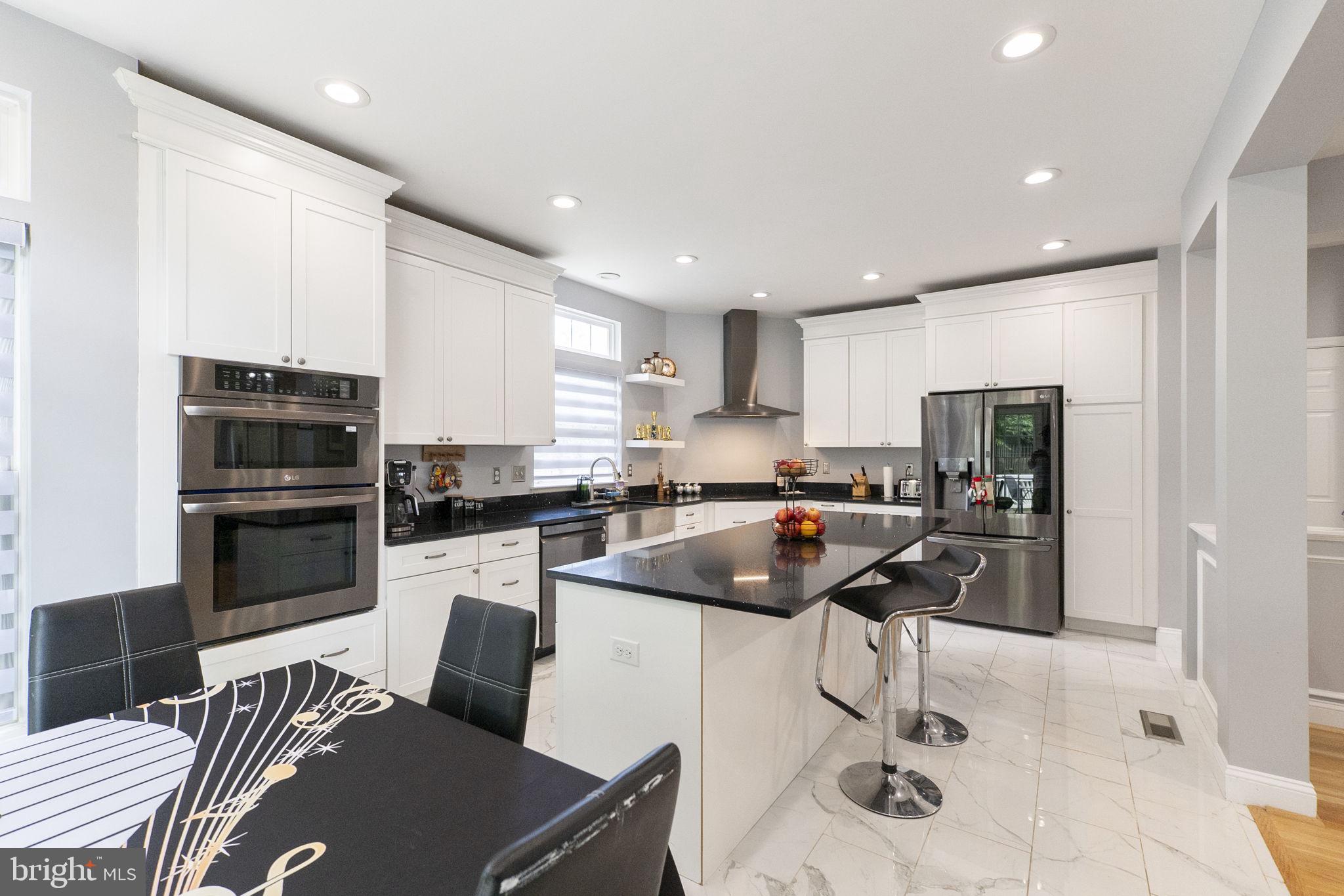 6455 Saddlebrook Lane Frederick, MD 21701 - Photo 12 of 38 a kitchen with stainless steel appliances a stove a sink a microwave a refrigerator and cabinets