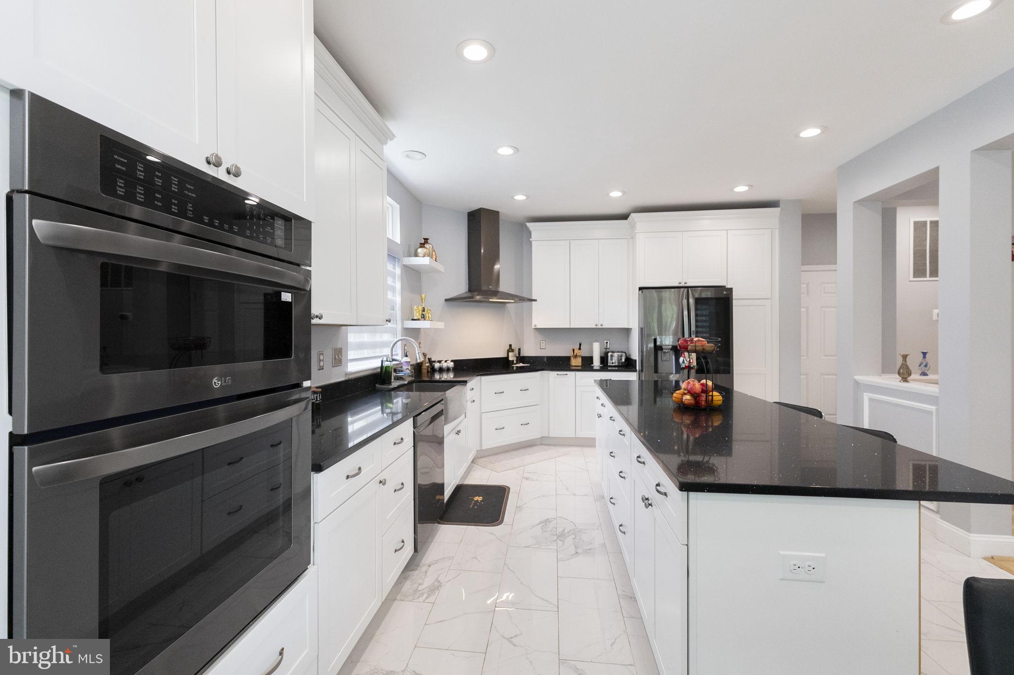 6455 Saddlebrook Lane Frederick, MD 21701 - Photo 14 of 38 a kitchen with stainless steel appliances granite countertop a sink a stove top oven a counter space and cabinets