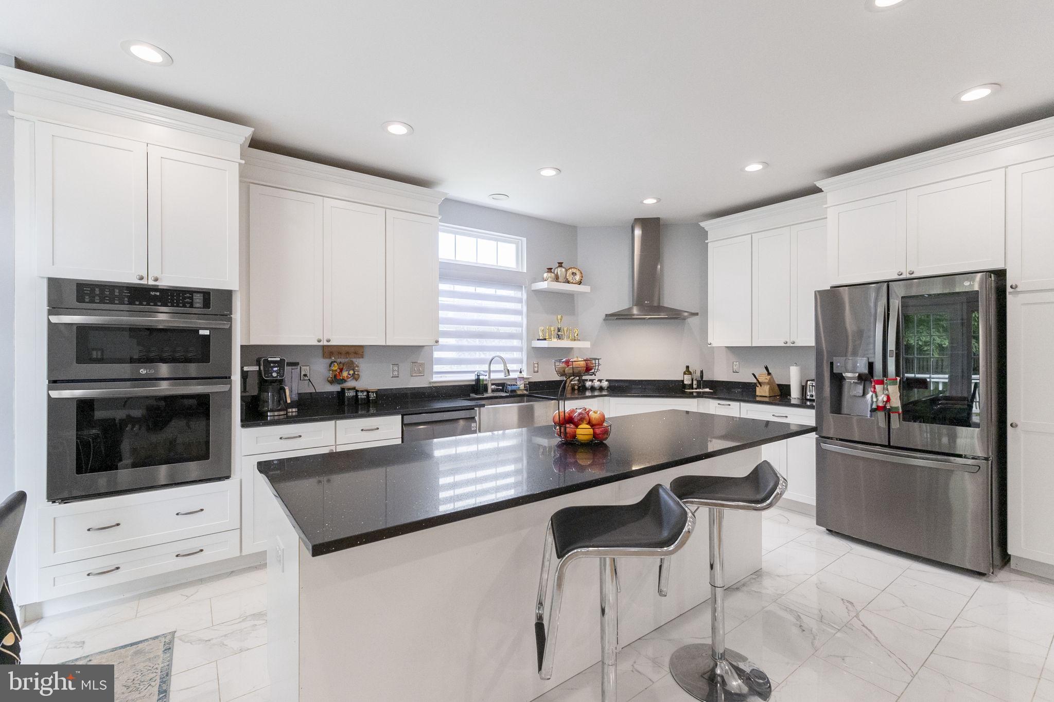 6455 Saddlebrook Lane Frederick, MD 21701 - Photo 15 of 38 a kitchen with stainless steel appliances granite countertop a refrigerator and a stove top oven