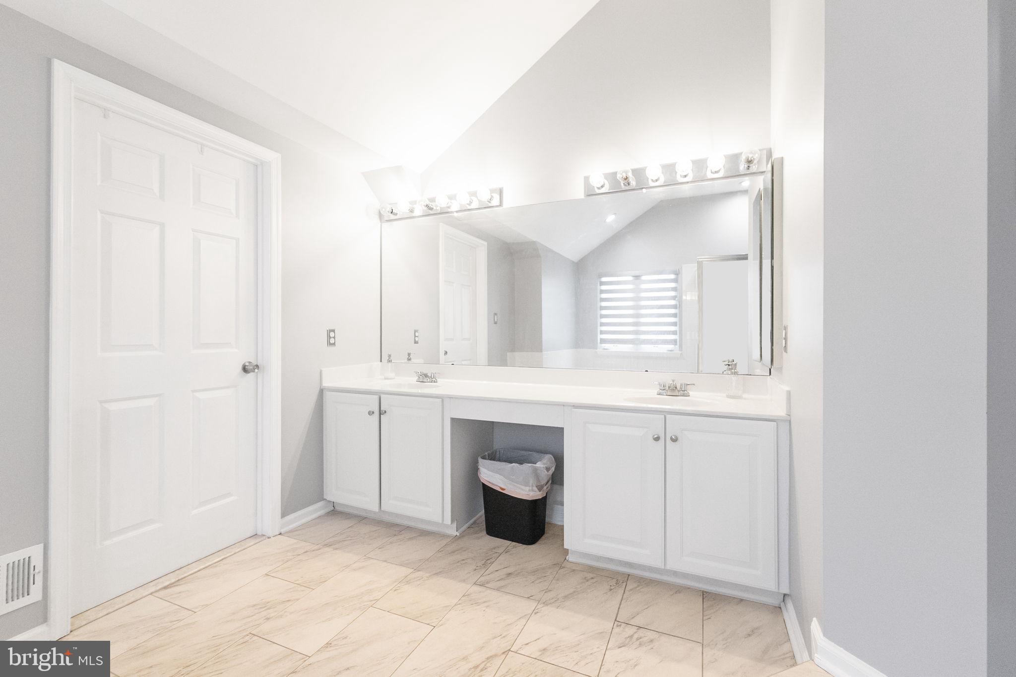 6455 Saddlebrook Lane Frederick, MD 21701 - Photo 23 of 38 a spacious bathroom with a granite countertop sink mirror and