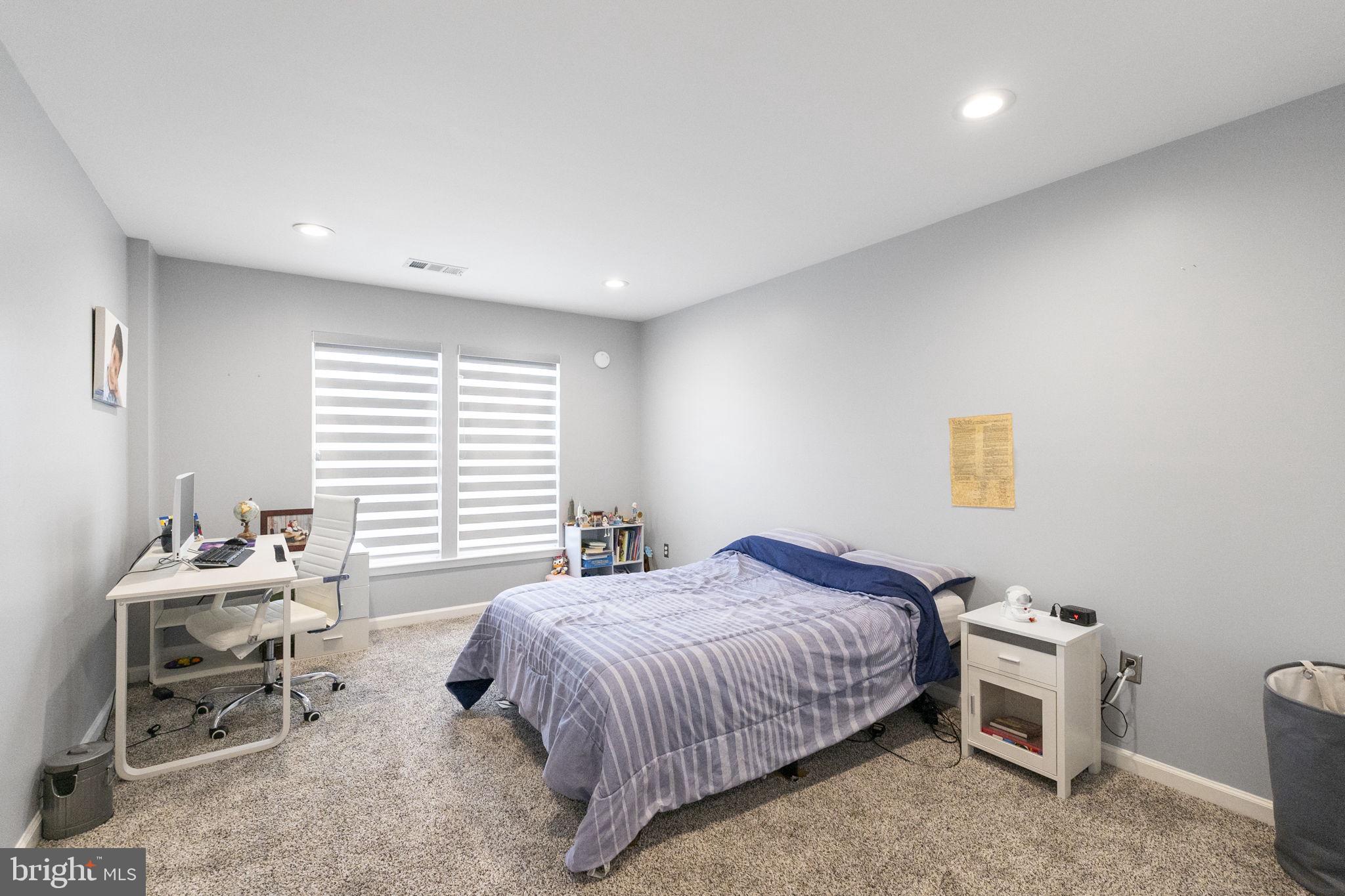 6455 Saddlebrook Lane Frederick, MD 21701 - Photo 26 of 38 a spacious bedroom with a bed and a window