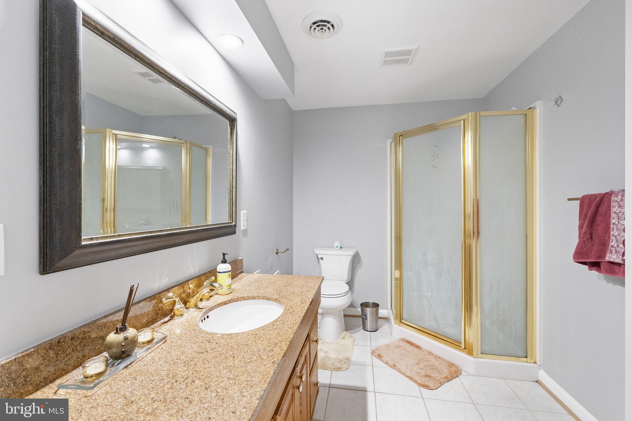 6455 Saddlebrook Lane Frederick, MD 21701 - Photo 27 of 38 a bathroom with a granite countertop sink and a mirror