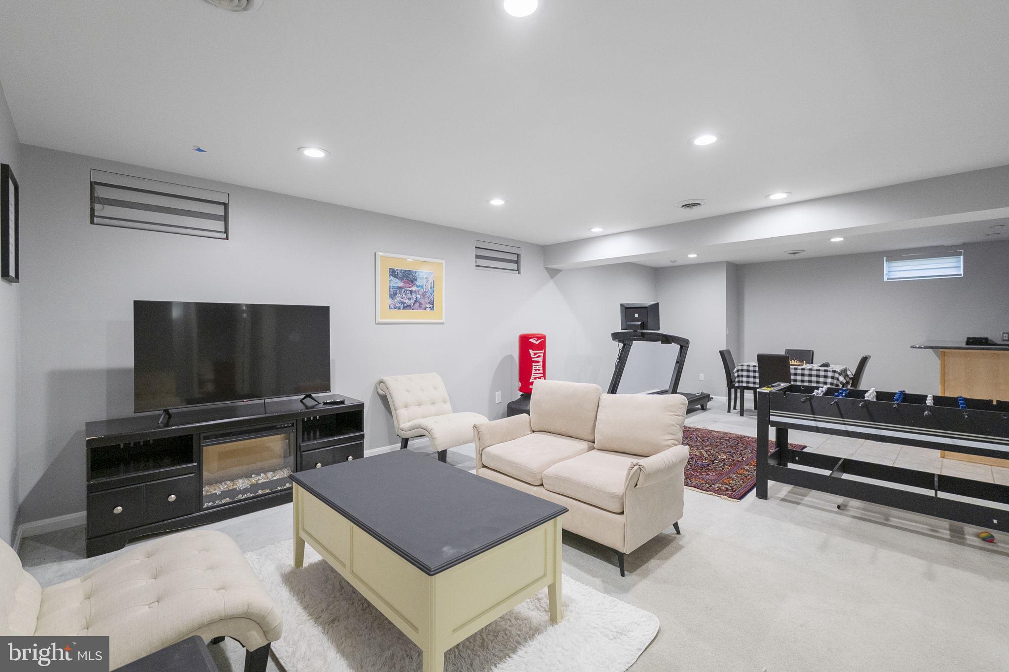 6455 Saddlebrook Lane Frederick, MD 21701 - Photo 28 of 38 a living room with furniture and a flat screen tv