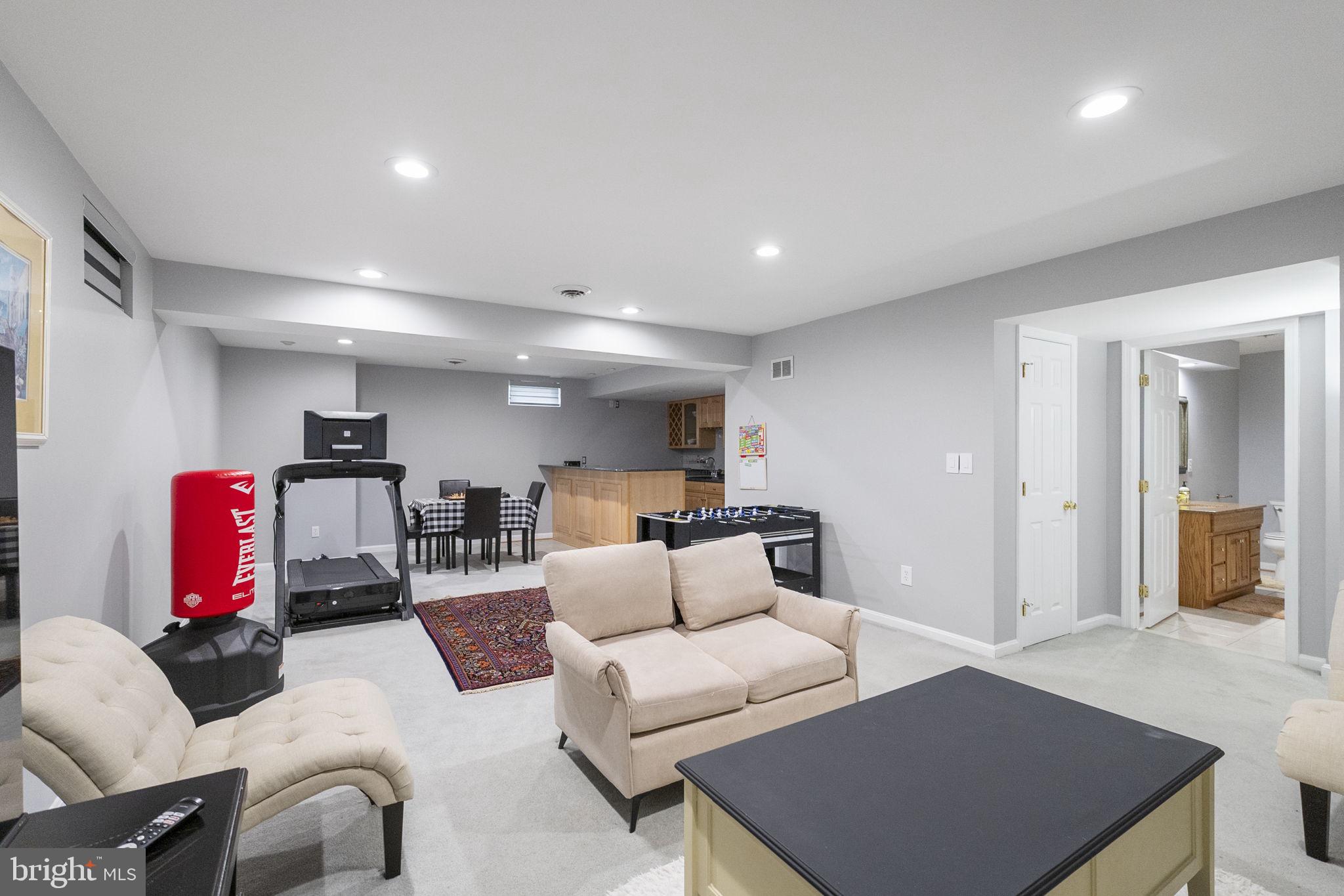 6455 Saddlebrook Lane Frederick, MD 21701 - Photo 29 of 38 a living room with furniture and a flat screen tv