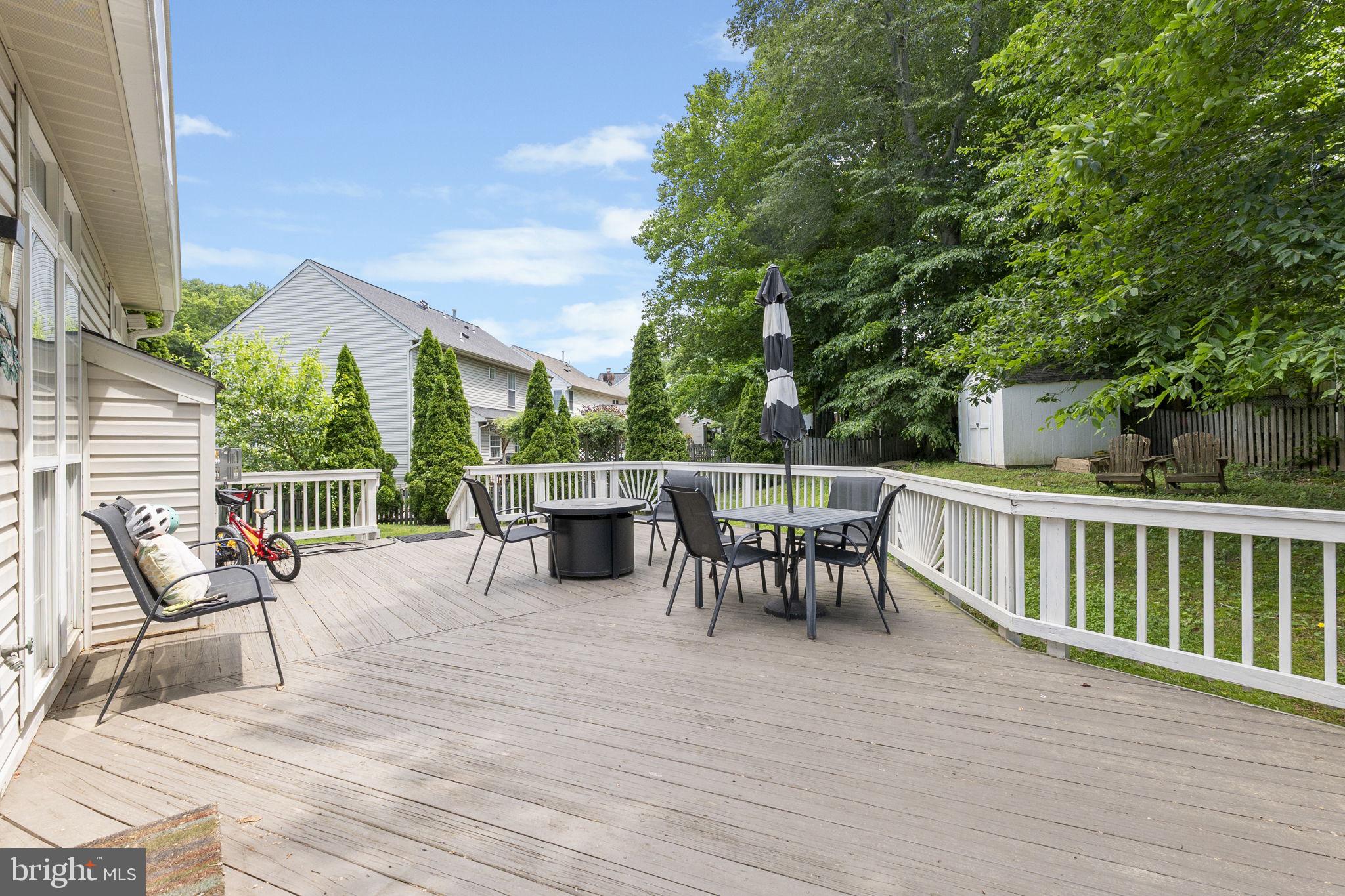 6455 Saddlebrook Lane Frederick, MD 21701 - Photo 33 of 38 a view of a patio with a dining table and chairs with wooden floor and fence
