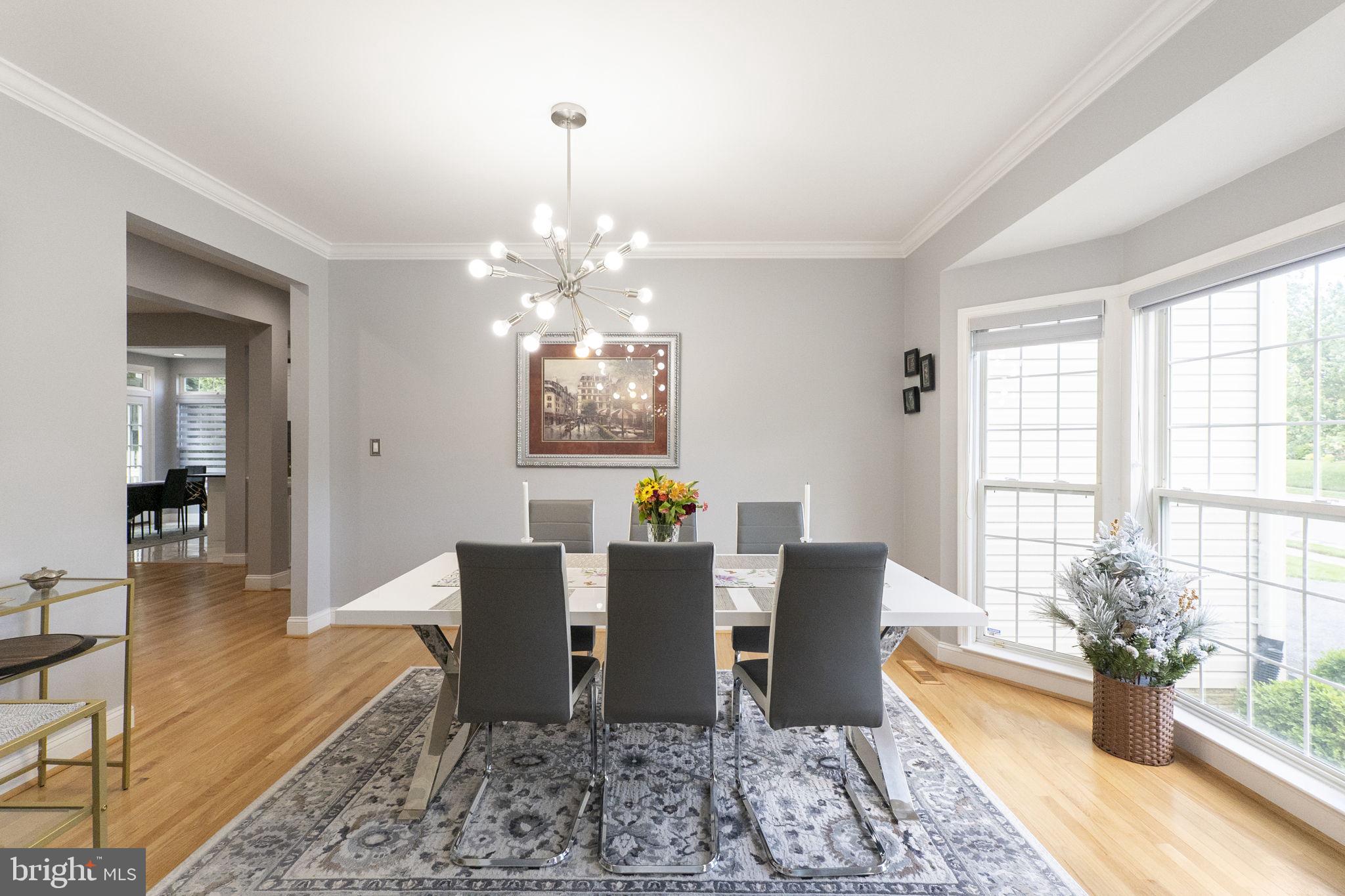 6455 Saddlebrook Lane Frederick, MD 21701 - Photo 4 of 38 a view of a dining room with furniture a chandelier and wooden floor