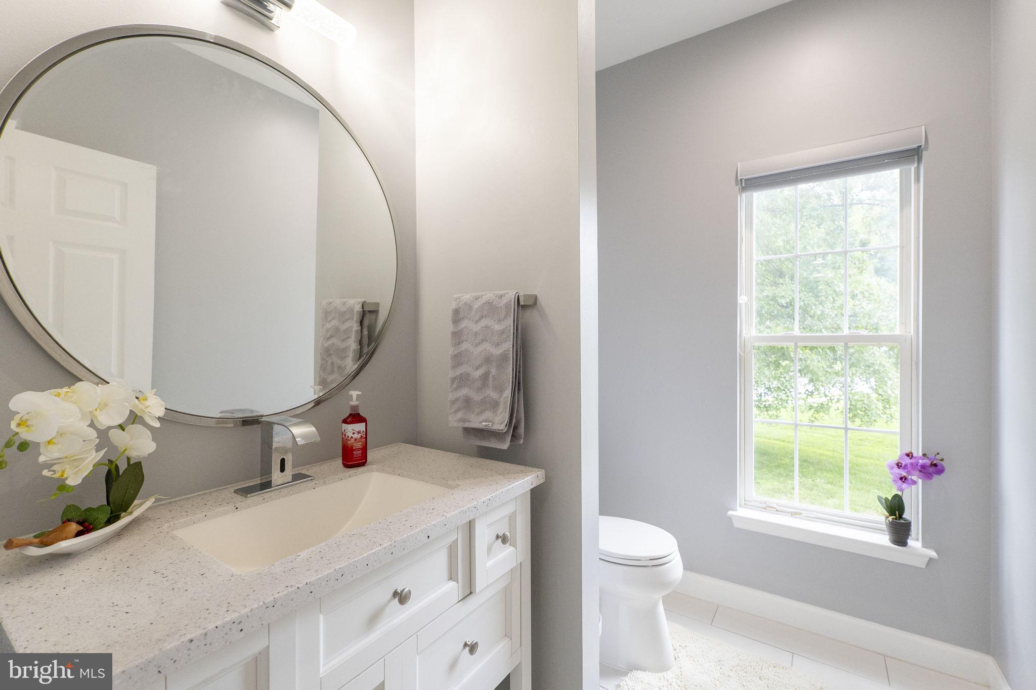 6455 Saddlebrook Lane Frederick, MD 21701 - Photo 7 of 38 a bathroom with a sink mirror toilet and next to a window