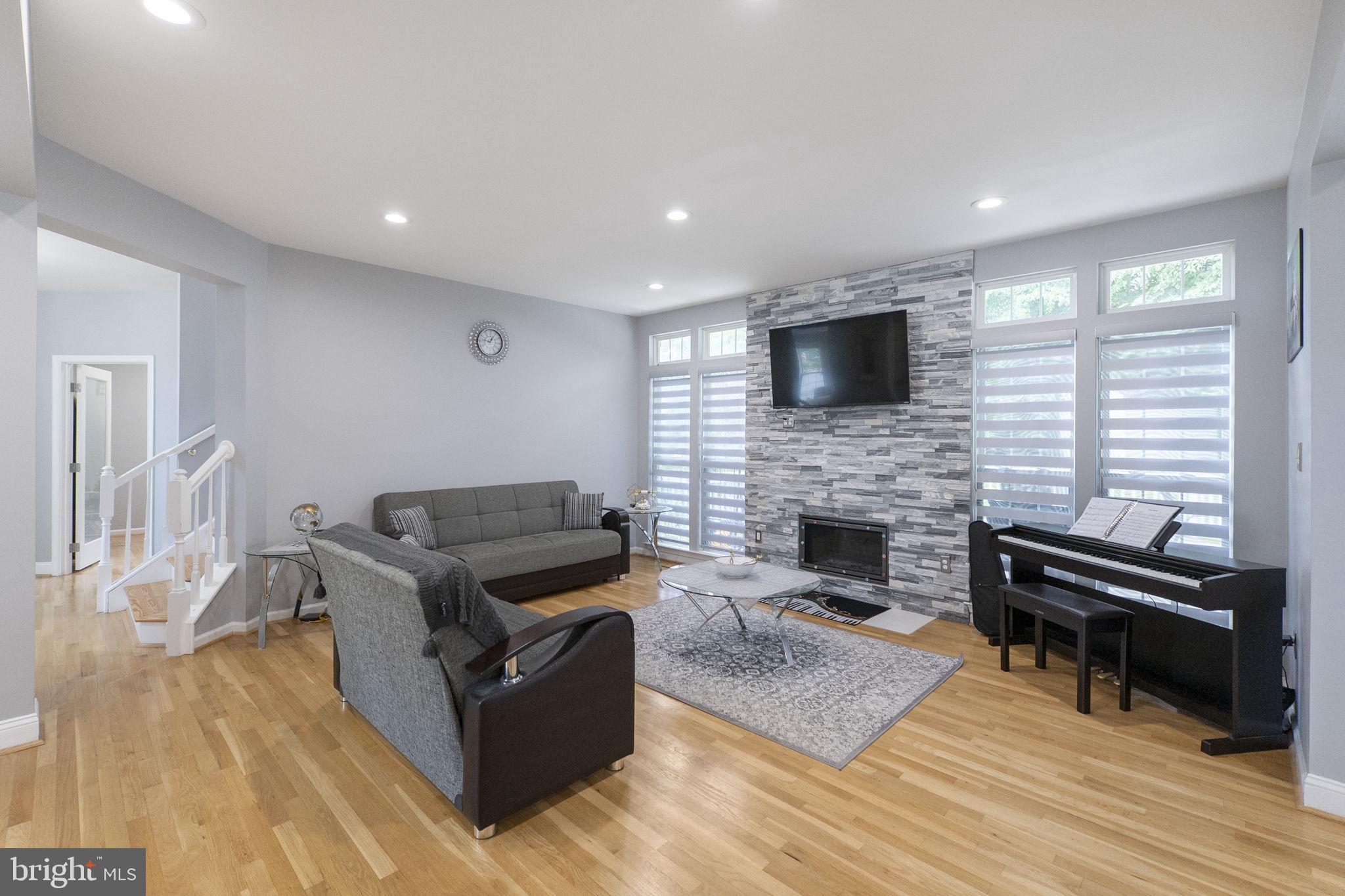 6455 Saddlebrook Lane Frederick, MD 21701 - Photo 10 of 38 a living room with furniture a flat screen tv and a fireplace