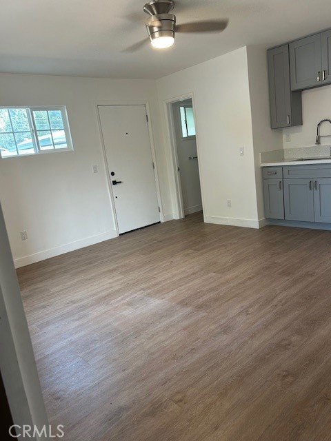 4568 Edgewood Place Riverside, CA 92506 - Photo 4 of 10 an empty room with wooden floor cabinet and windows