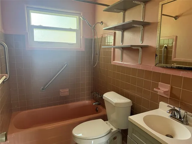a bathroom with a sink a toilet and bathtub