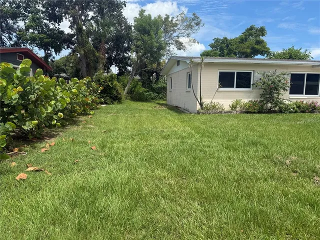 a front view of house with yard and trees