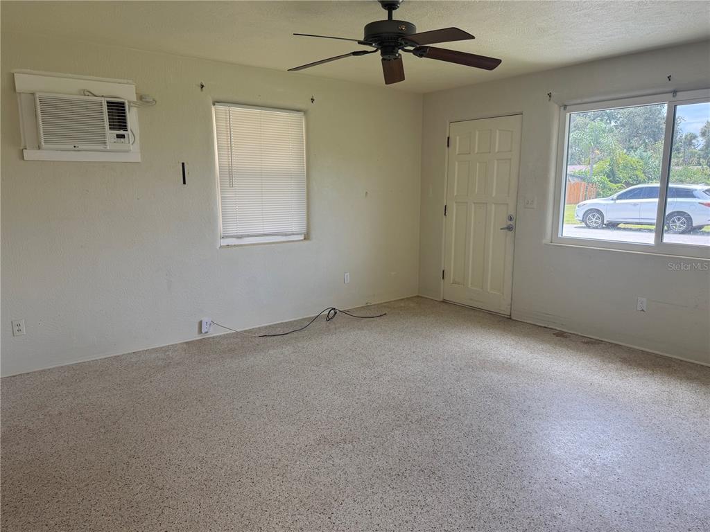 113 Neptune Drive Edgewater, FL 32132 - Photo 4 of 24 a view of an empty room with a window