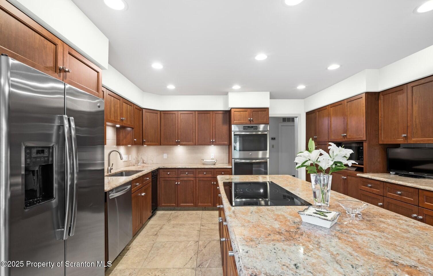 325 T-718 Shavertown, PA 18708 - Photo 11 of 41 a kitchen with stainless steel appliances kitchen island granite countertop a refrigerator and a sink