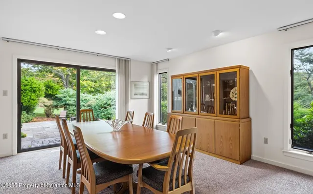 a view of a dining room with furniture window and outside view
