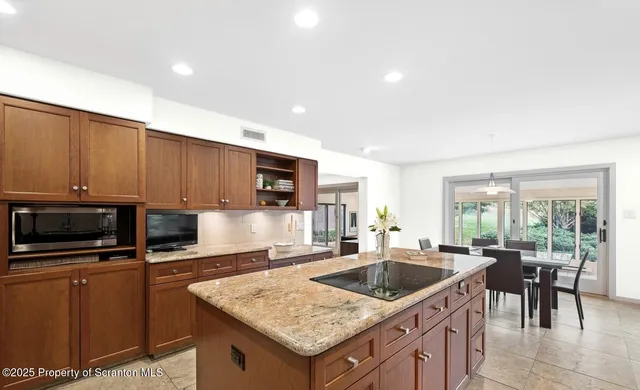 a kitchen with a stove a sink and a microwave