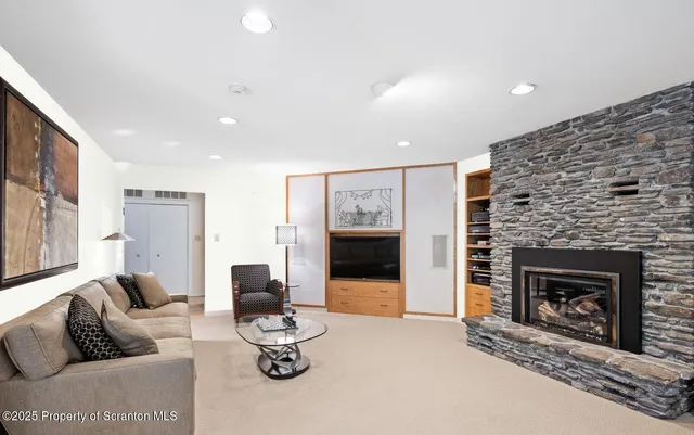 a living room with furniture and a fireplace
