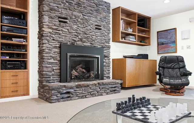 a room with a fireplace and cabinets