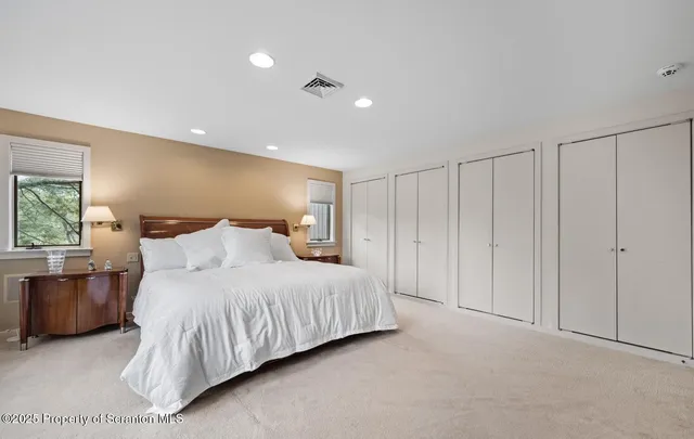 a bedroom with a large bed and a night stand