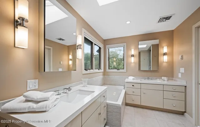 a spacious bathroom with a granite countertop sink mirror and double