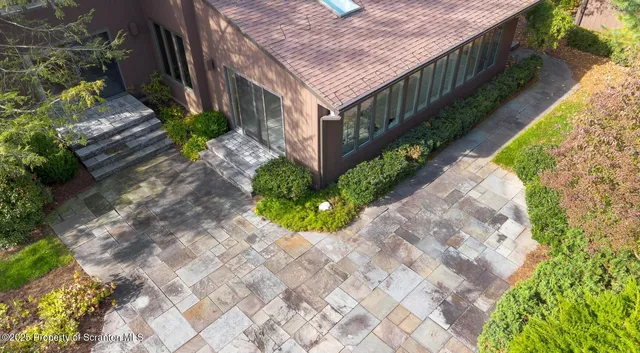 a view of a house with a small yard and plants