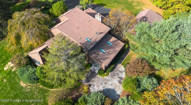 an aerial view of a house with a yard