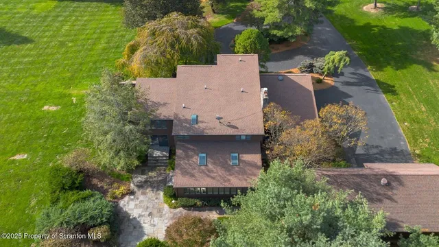 an aerial view of a house with a yard