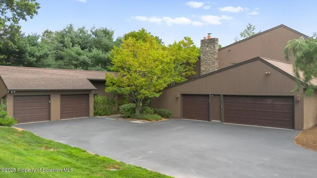 a view of a house with a yard and garage