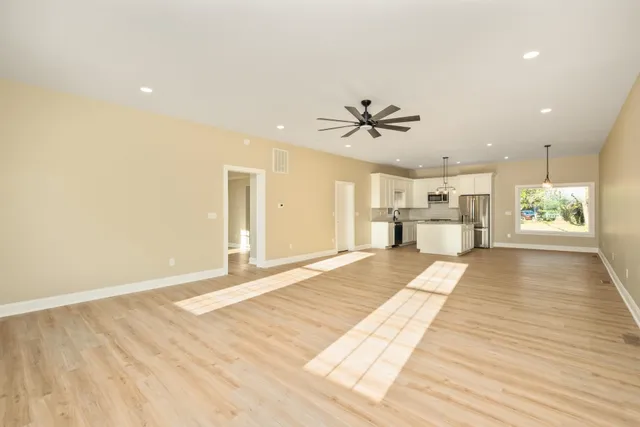 a view of a small space with wooden floor and a window