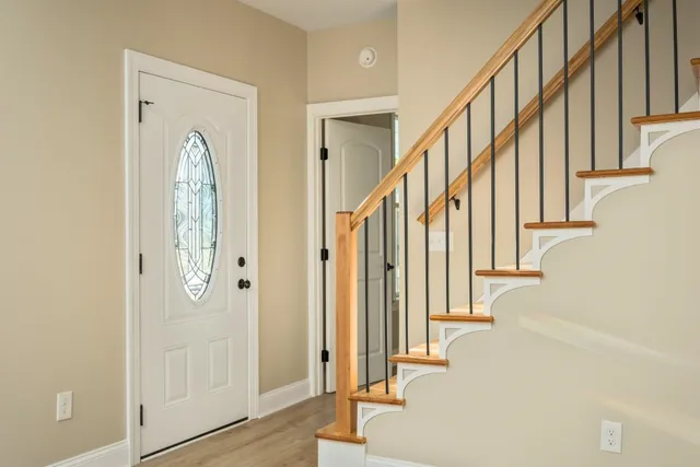 a view of entryway with wooden floor and door