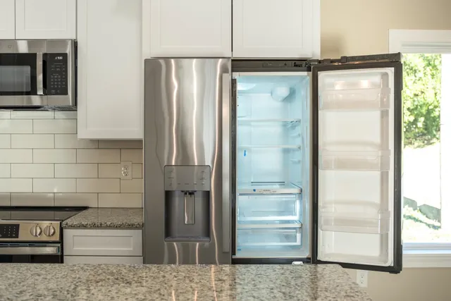 a bathroom with a glass shower door and a sink