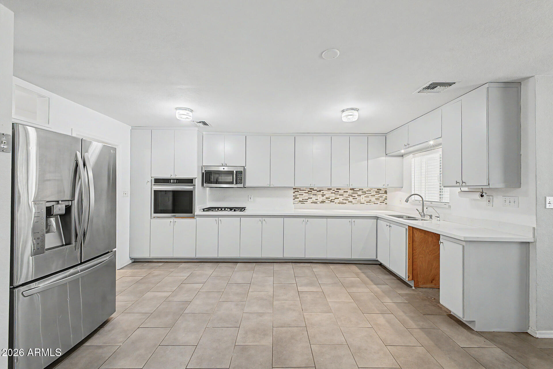 3907 East Mulberry Drive Phoenix, AZ 85018 - Photo 10 of 48 a large kitchen with cabinets and stainless steel appliances