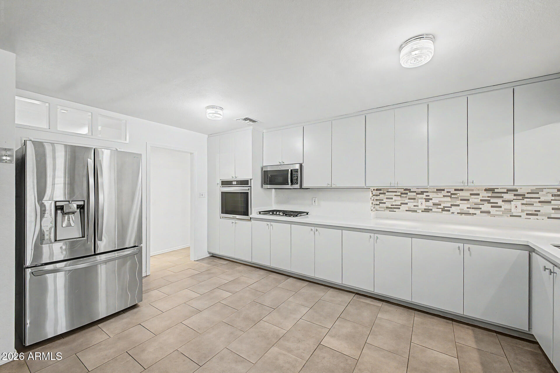 3907 East Mulberry Drive Phoenix, AZ 85018 - Photo 12 of 48 a kitchen with stainless steel appliances granite countertop a refrigerator sink and cabinets