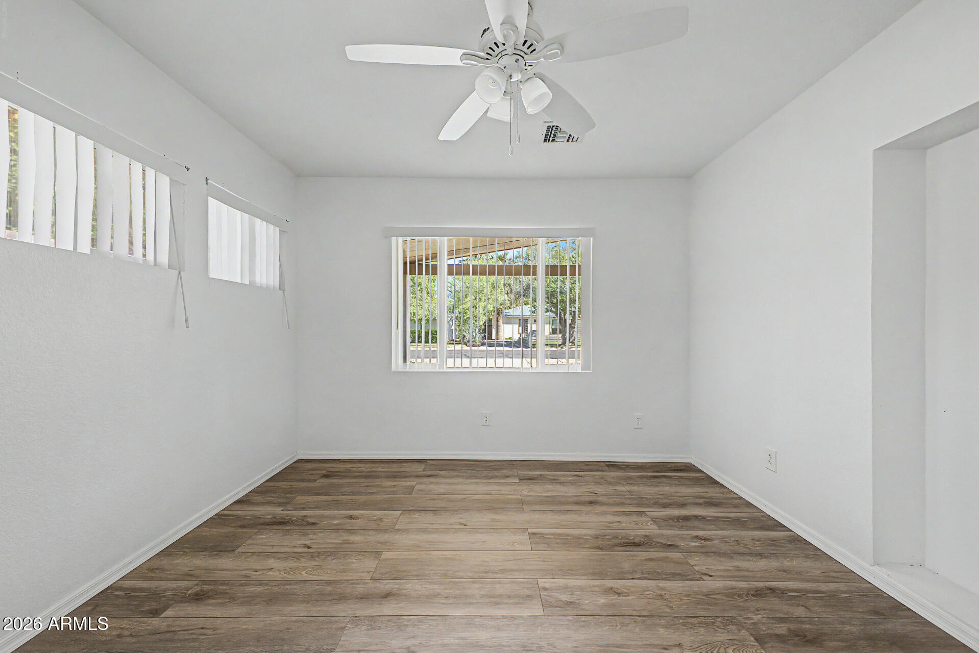 3907 East Mulberry Drive Phoenix, AZ 85018 - Photo 14 of 48 a view of empty room with wooden floor and fan