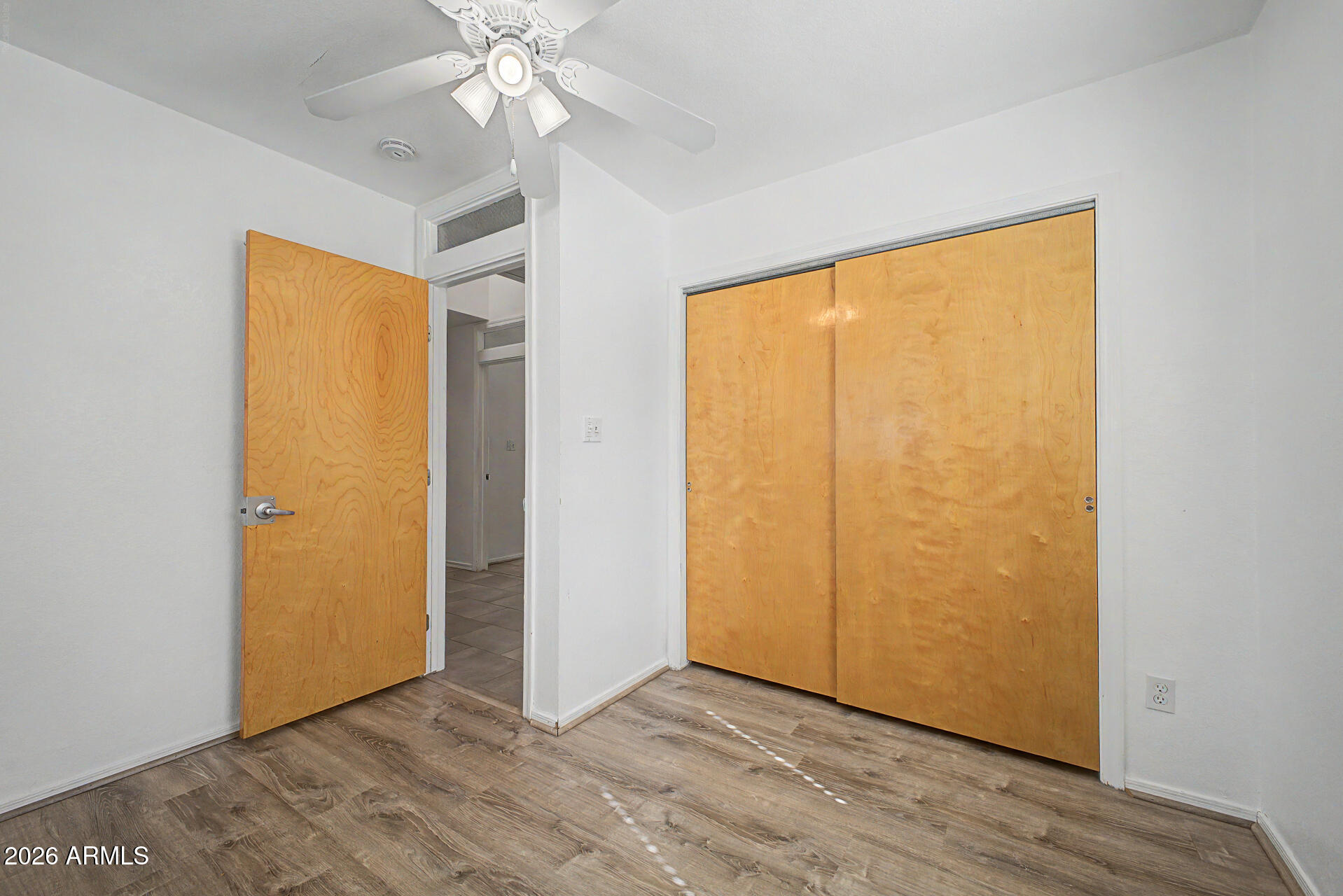 3907 East Mulberry Drive Phoenix, AZ 85018 - Photo 20 of 48 a view of an empty room with wooden floor and a window