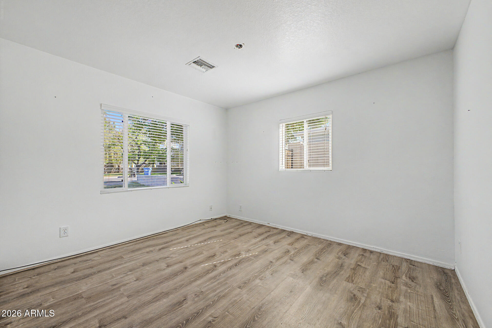 3907 East Mulberry Drive Phoenix, AZ 85018 - Photo 21 of 48 wooden floor in an empty room with a window