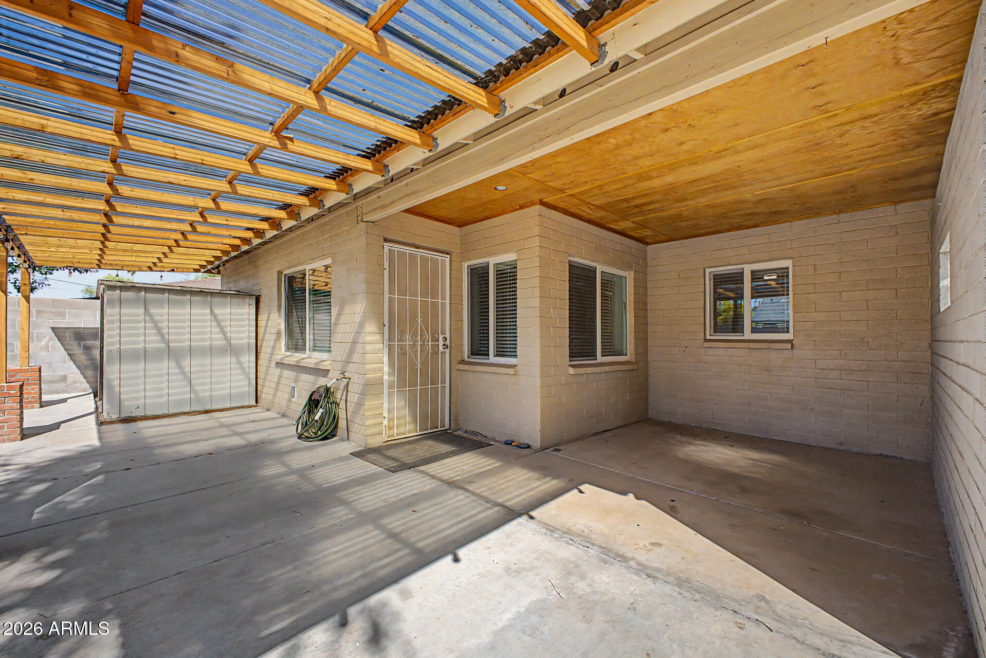 3907 East Mulberry Drive Phoenix, AZ 85018 - Photo 32 of 48 a view of a porch with wooden floor and fence