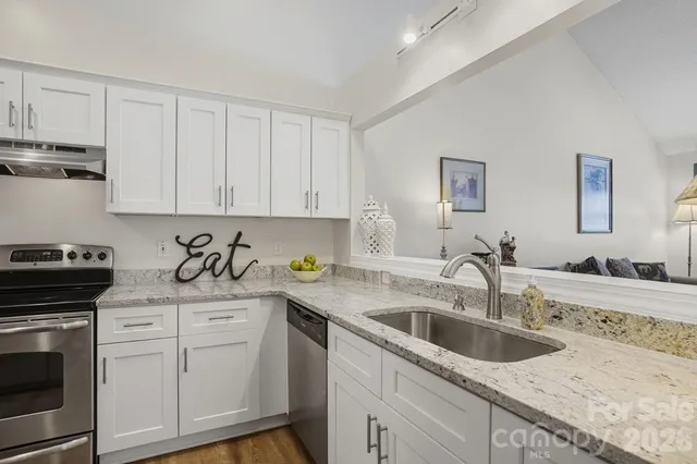 a bathroom with a granite countertop toilet sink and mirror