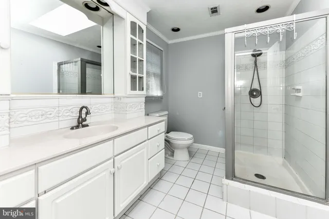 a bathroom with a sink shower and a mirror