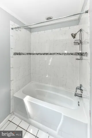 a bathroom with a shower and a bath tub