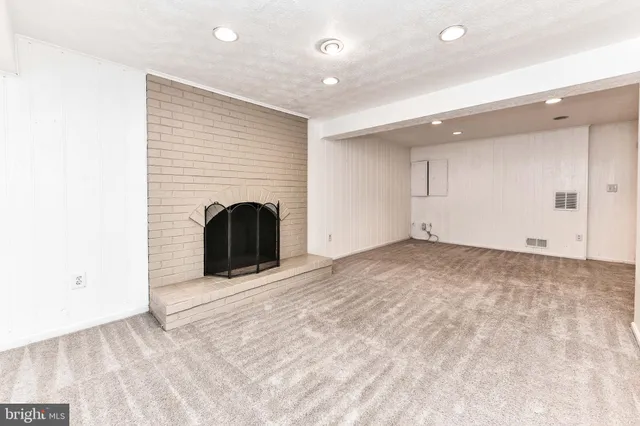 a view of an empty room with a fireplace