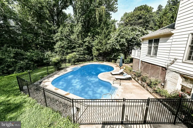 swimming pool view with a seating space