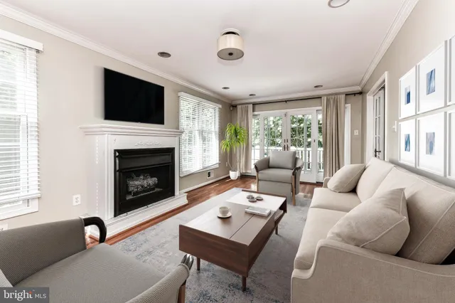 a living room with furniture flat screen tv and a fireplace