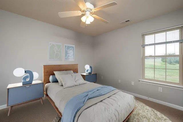 a bedroom with bed and window