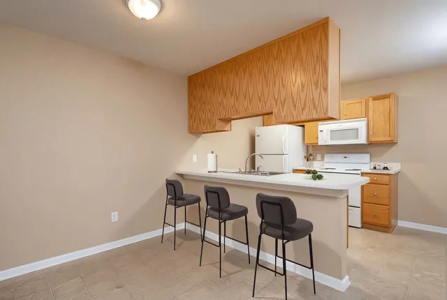 a kitchen with a sink cabinets and window