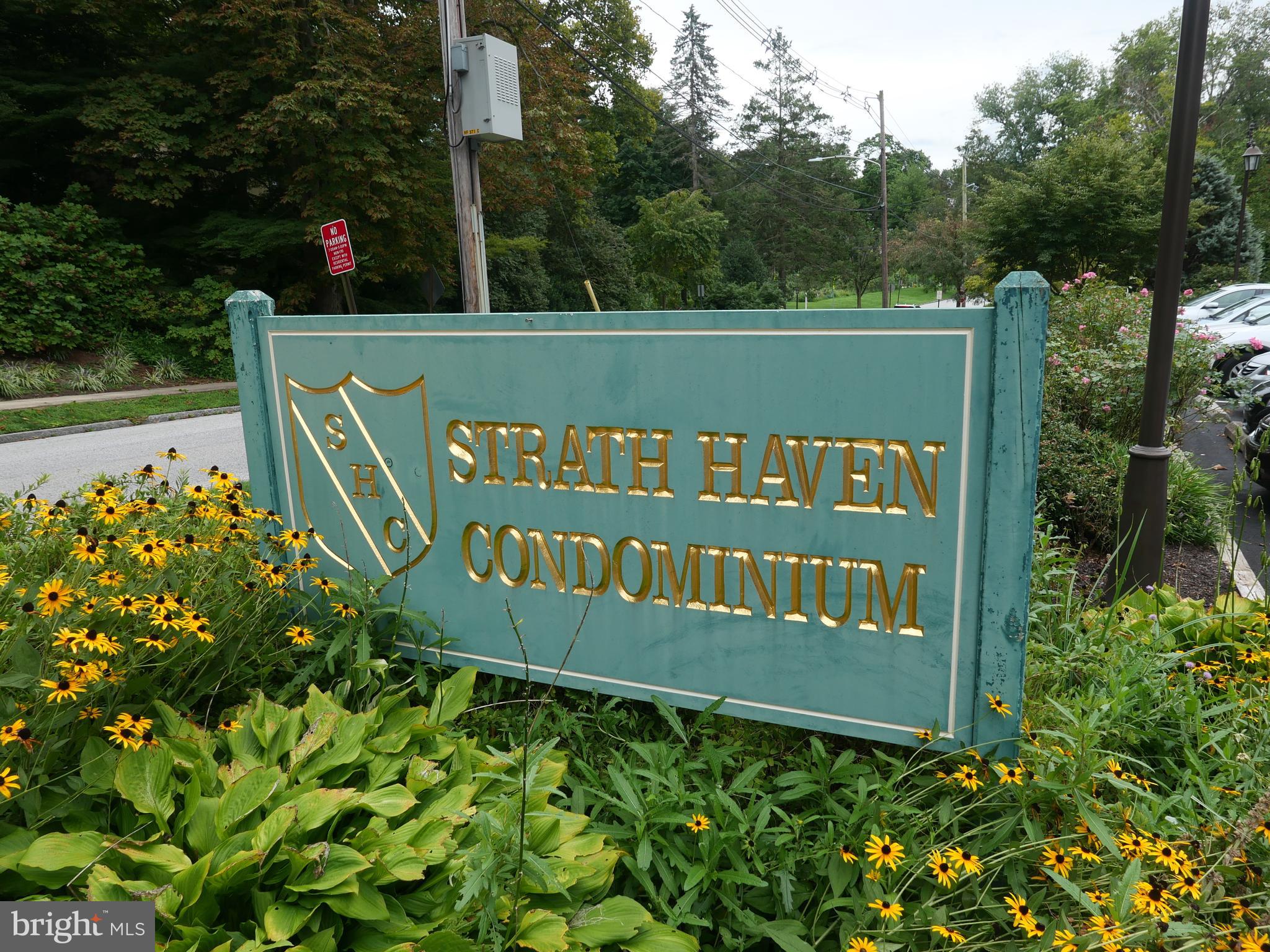 a view of sign board with flower plants