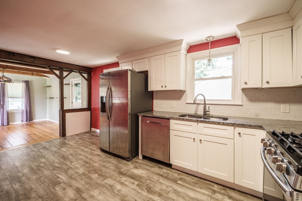 226 Dutchess Street Springfield, MA 01129 - Photo 12 of 39 a kitchen with stainless steel appliances granite countertop a stove a sink and a refrigerator