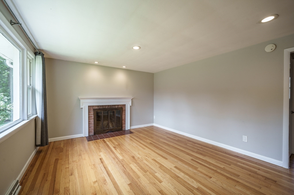 226 Dutchess Street Springfield, MA 01129 - Photo 14 of 39 an empty room with large windows and fireplace